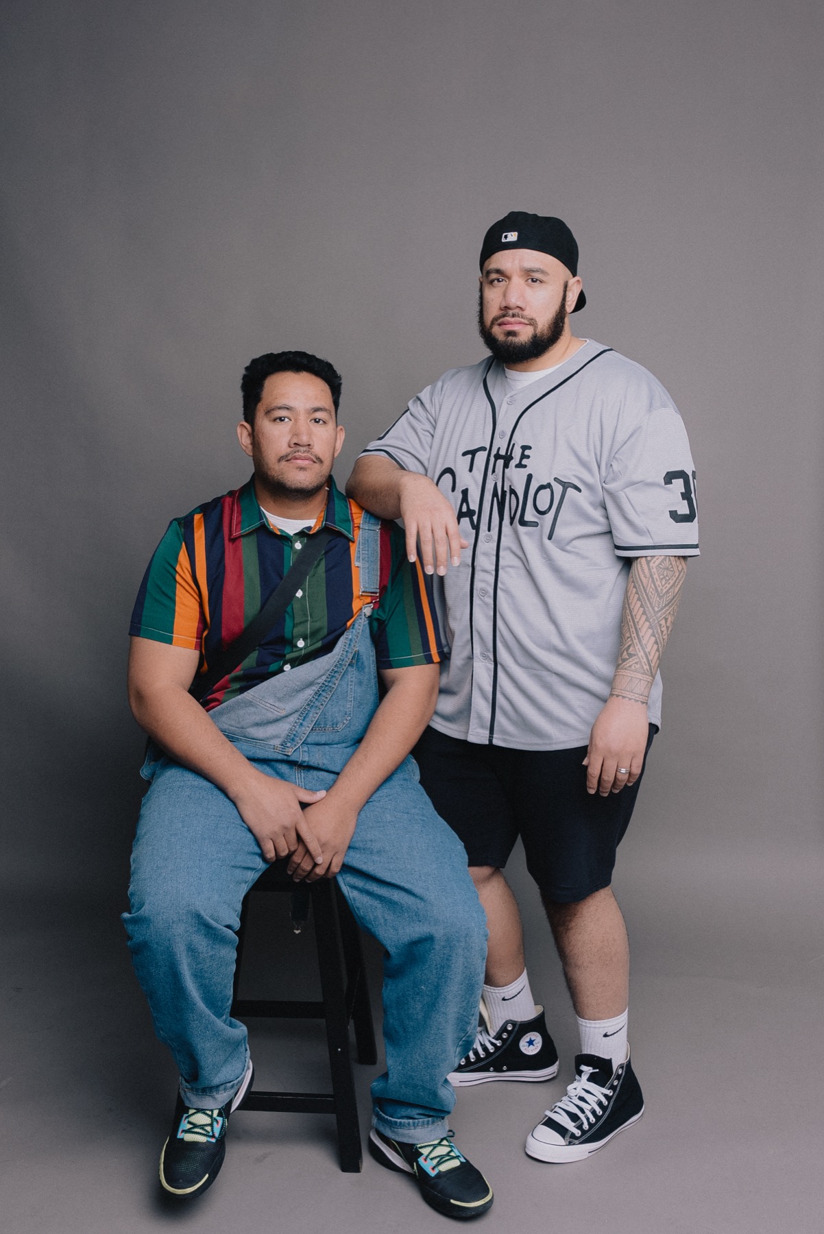 Two family members posing in a styled studio portrait