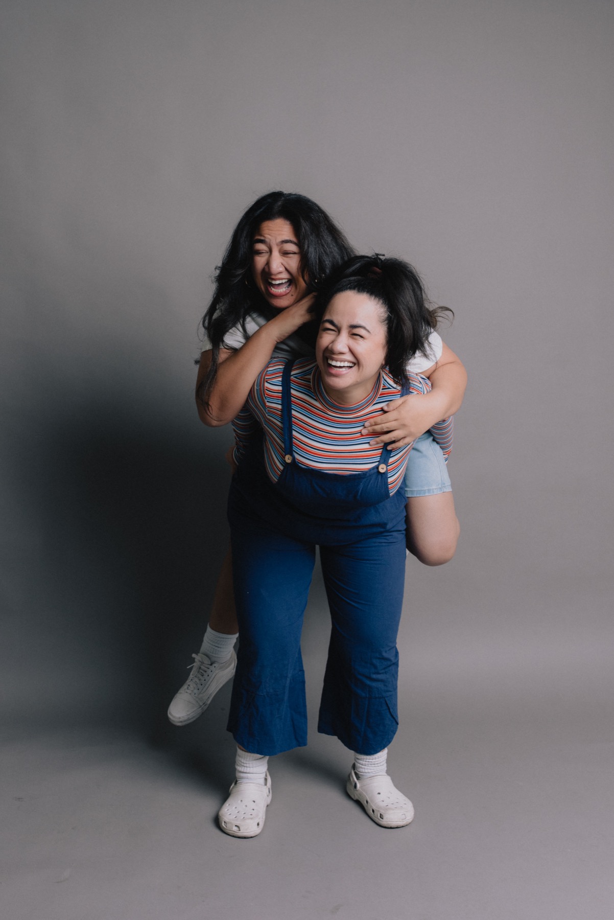 Family members laughing during a 90s-inspired studio portrait session