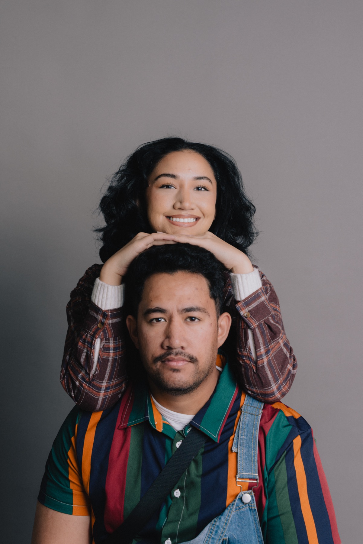 Family members posed together in a playful studio portrait