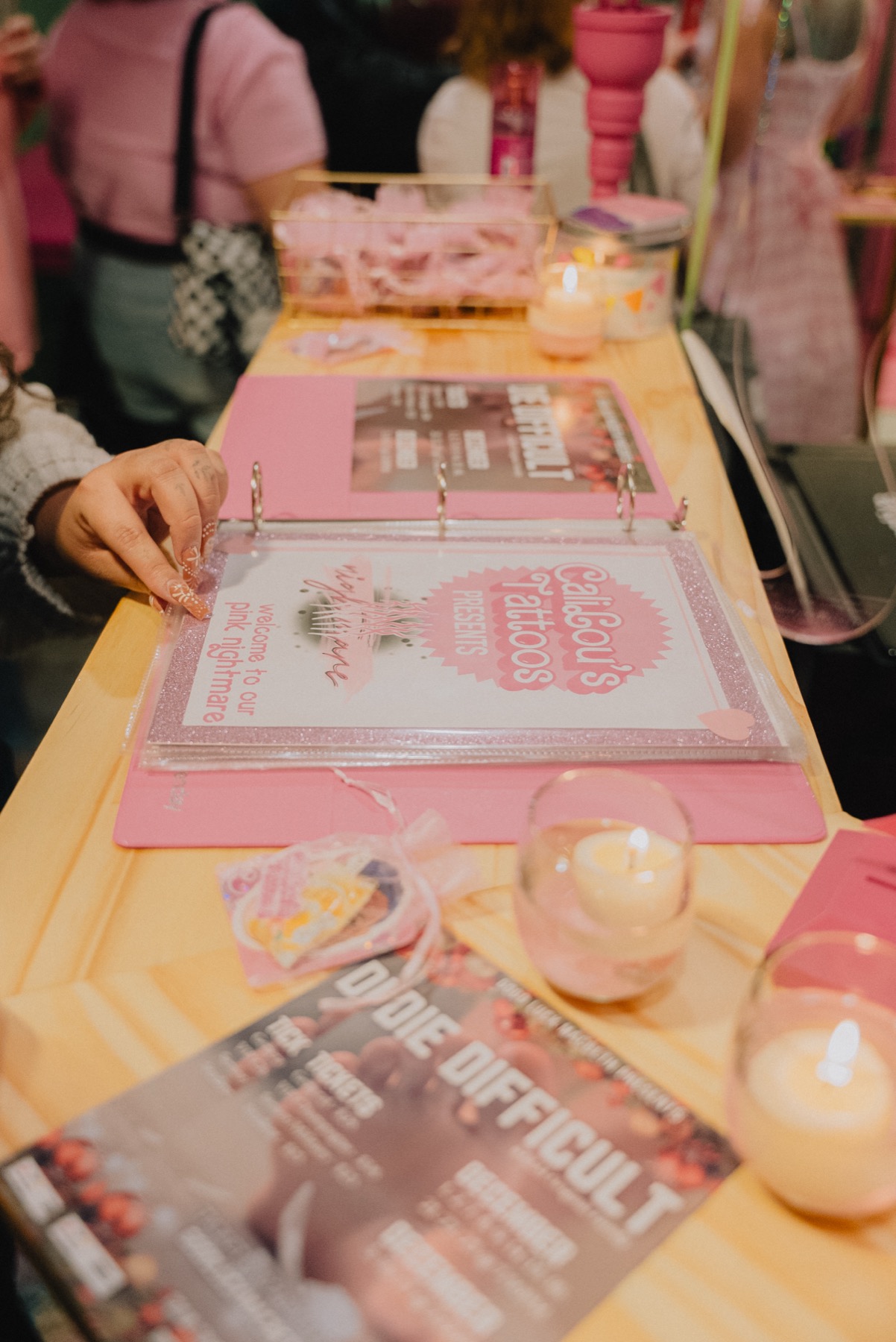 Pink event details and tattoo flash book at Callous Tattoo Studio