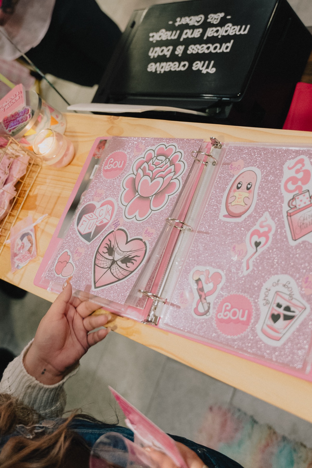 Pink flash book and tattoo designs at the Callous Tattoo Studio grand opening
