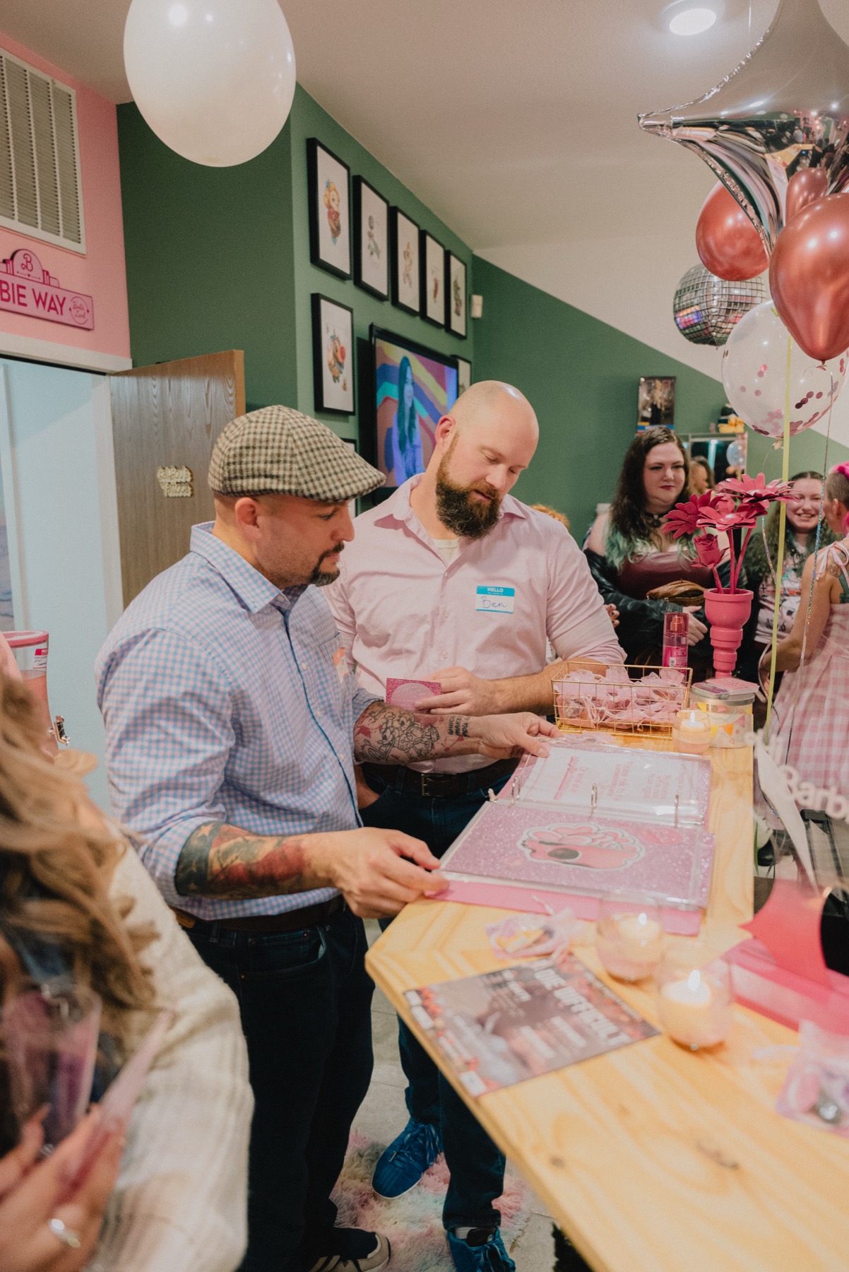 Guests looking through tattoo flash designs during the grand opening