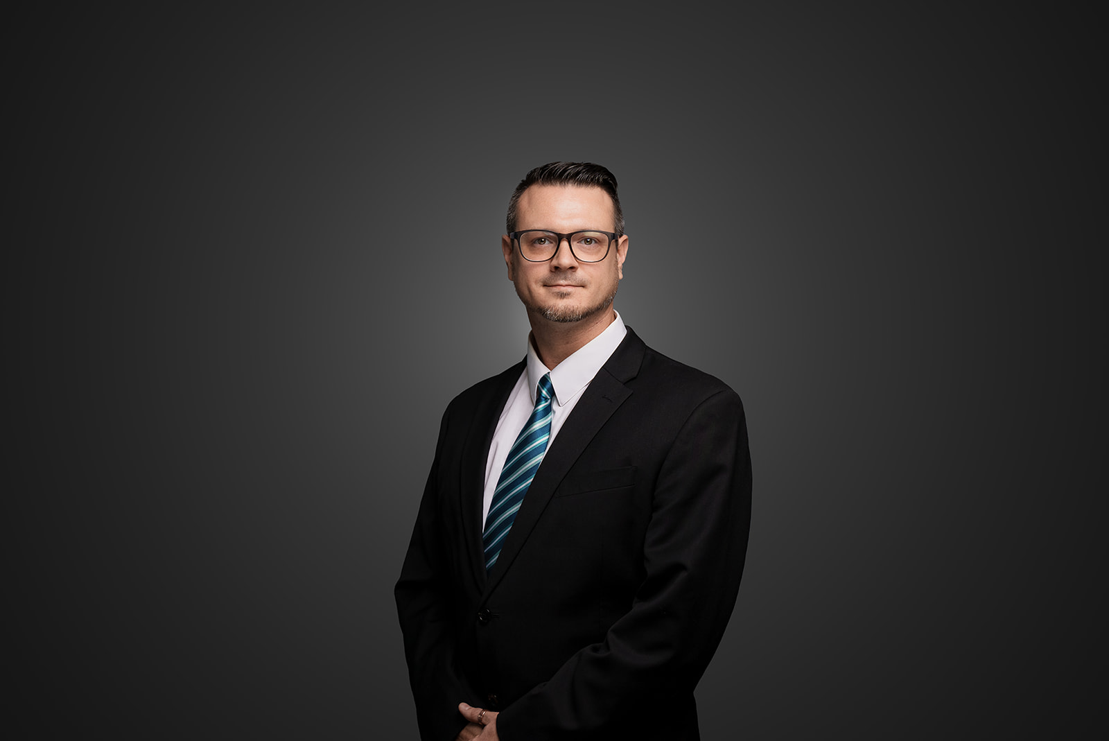 Professional Cintas employee headshot on a dark gray background