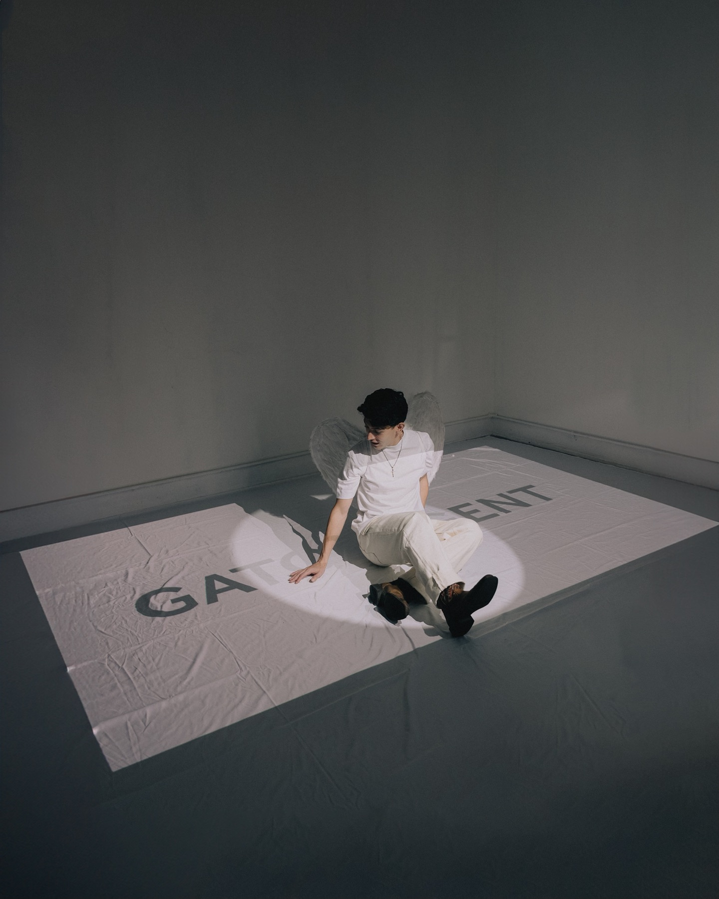 Edgar Gator Agent seated in a spotlight with angel wings and Celestial projection