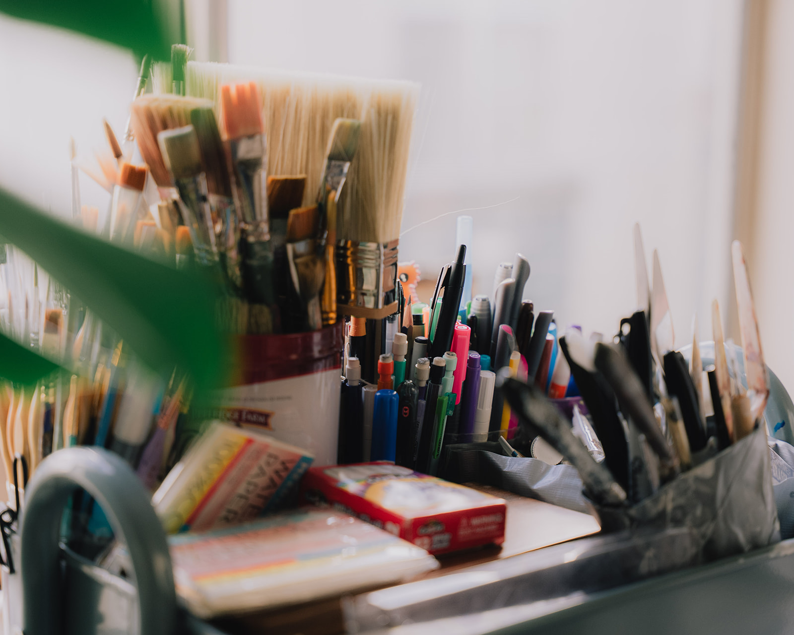 Paintbrushes and art materials in Haley’s studio